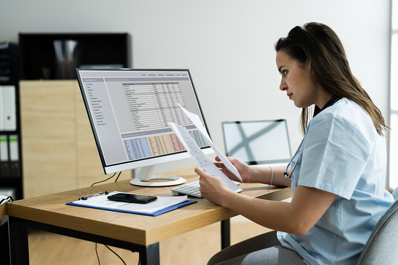 Healthcare administrator reviewing billing data and claim reports in an ABA clinic management system.