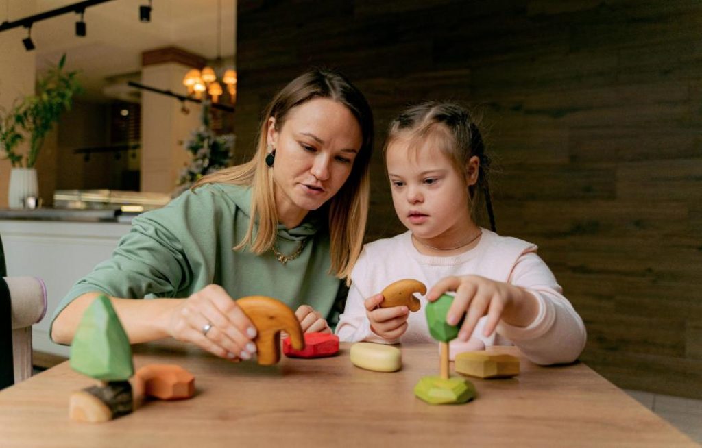 Therapist using play-based activities for teaching social skills autism during ABA therapy