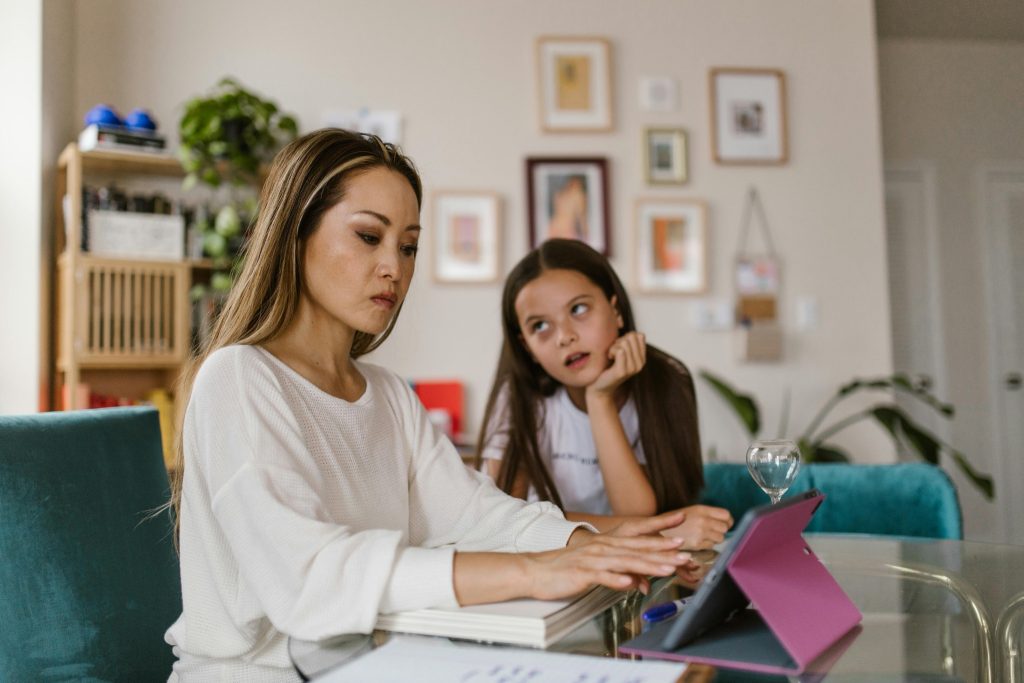 Mother with child at desk, showing positive reinforcement autism at home