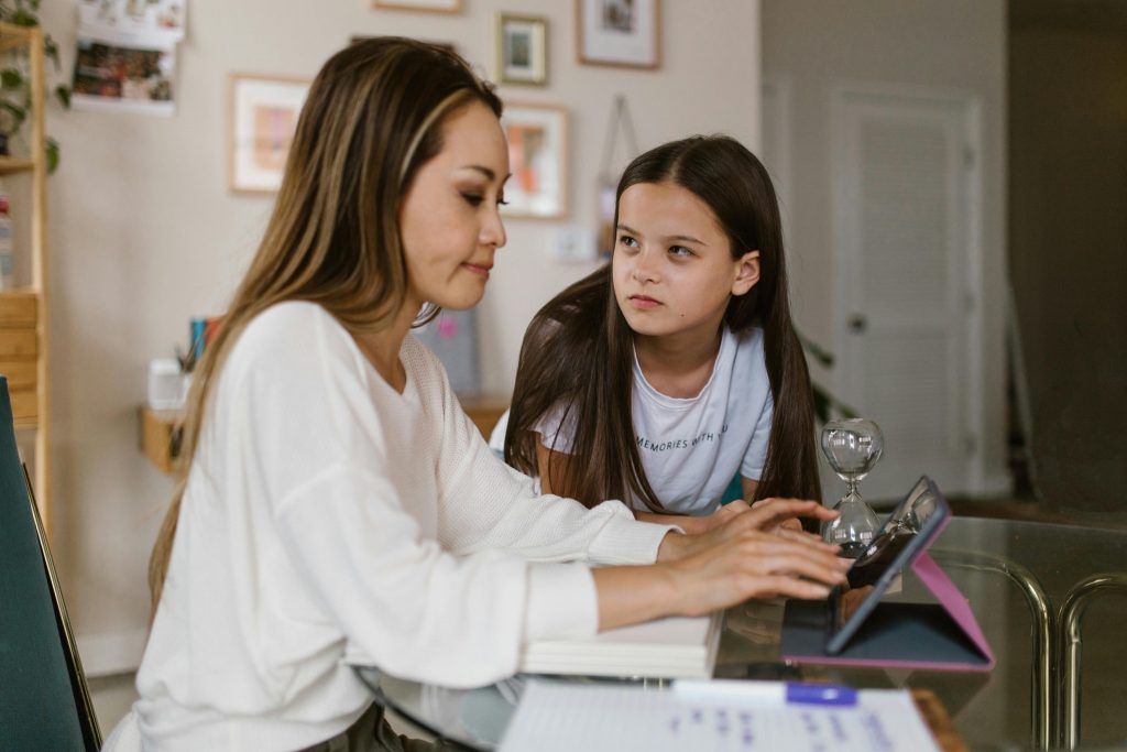 Mother with child at desk, showing positive reinforcement autism at home
